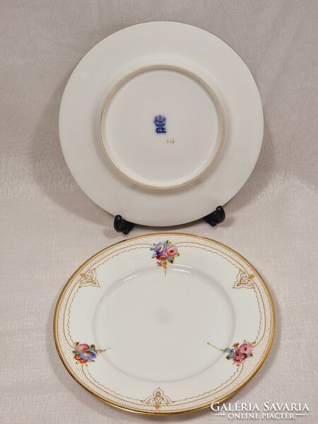 2 Tielsch display case gold-painted porcelain cookie plates with floral patterns.