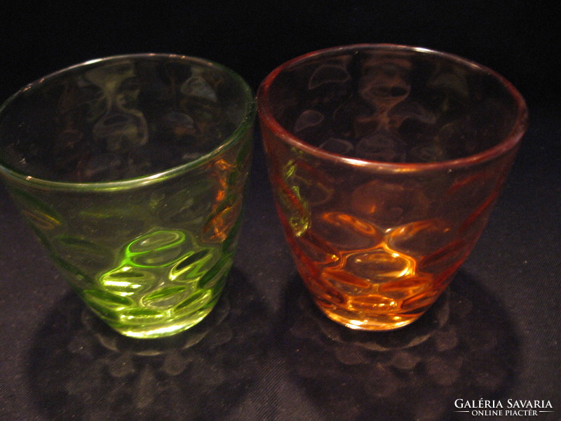 A pair of green and pink polka dot candle holders