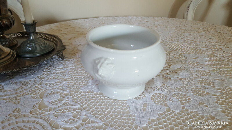 A small porcelain soup and sauce bowl with a lion's head and foot