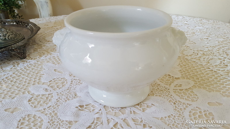 A small porcelain soup and sauce bowl with a lion's head and foot