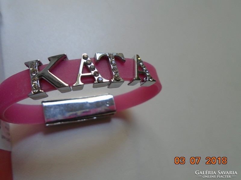 Modern pink wrist strap kata decorated with silver-plated, stone-encrusted letters