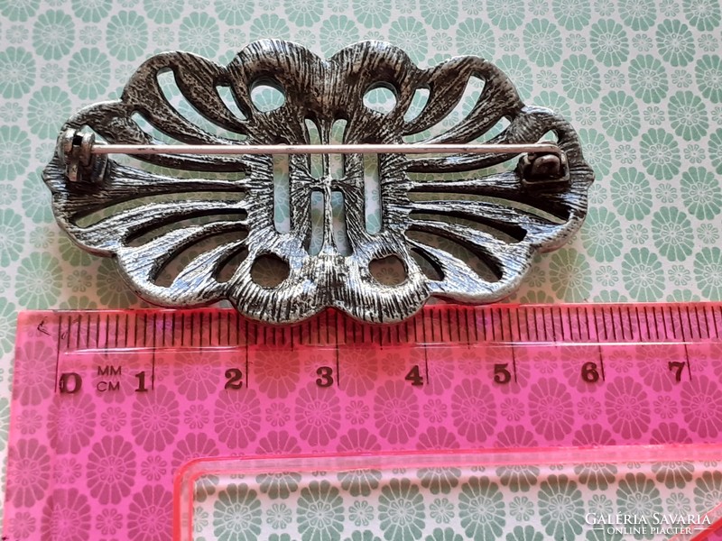 Old women's brooch with vintage metal badge