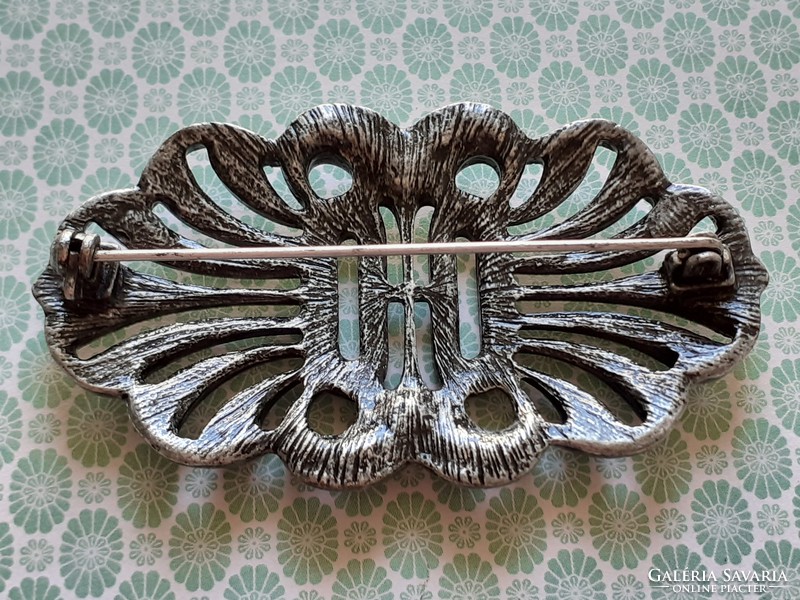 Old women's brooch with vintage metal badge
