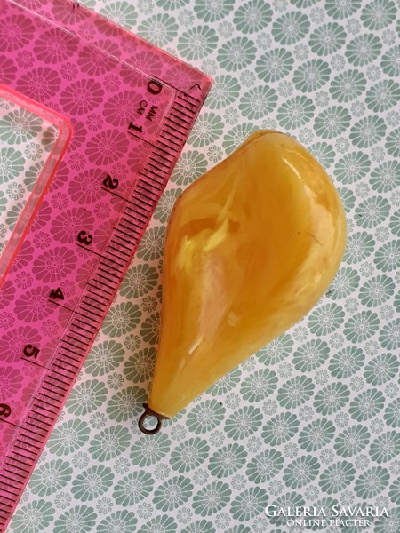 Old female plastic pendant in the shape of a drop