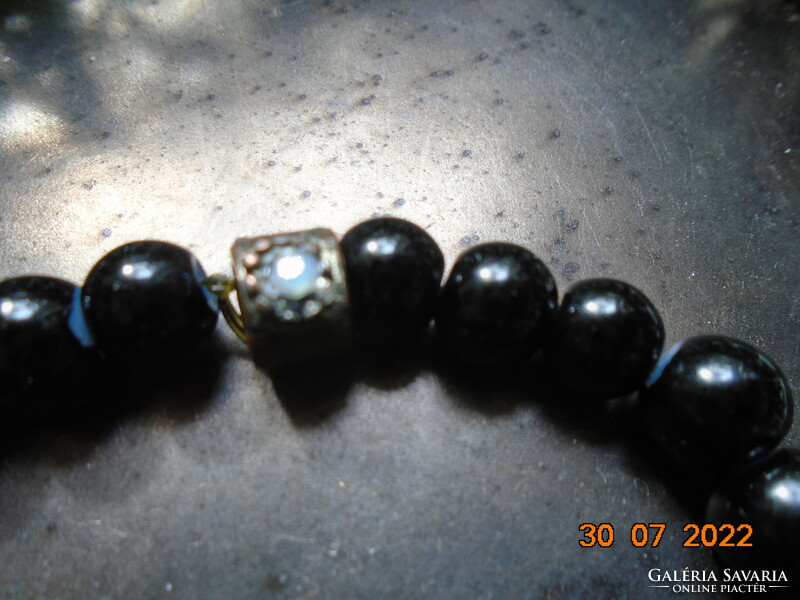 Black pearl bracelet with an interesting handcrafted bronze pearl decorated with 2 polished moonstones