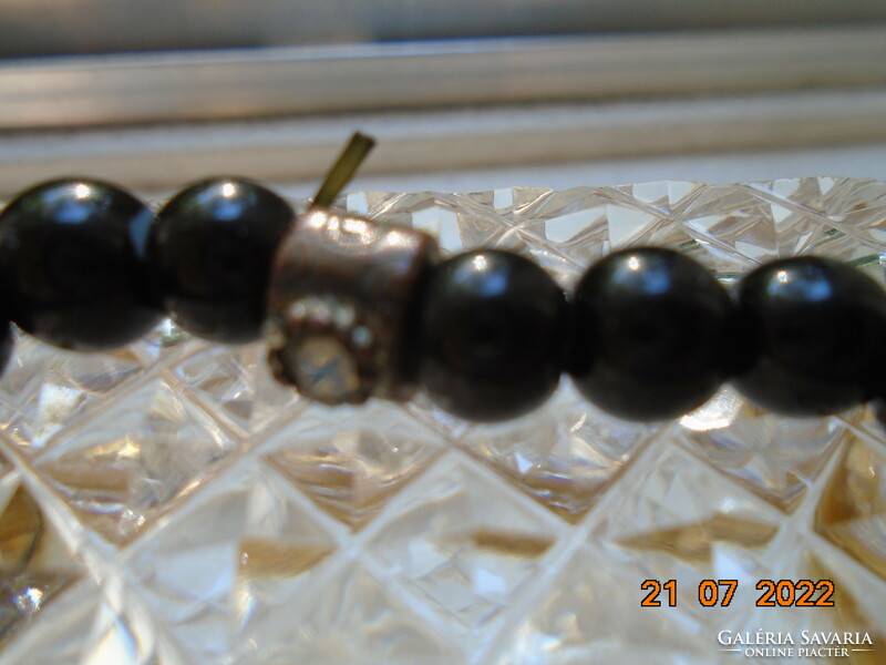 Black pearl bracelet with an interesting handcrafted bronze pearl decorated with 2 polished moonstones