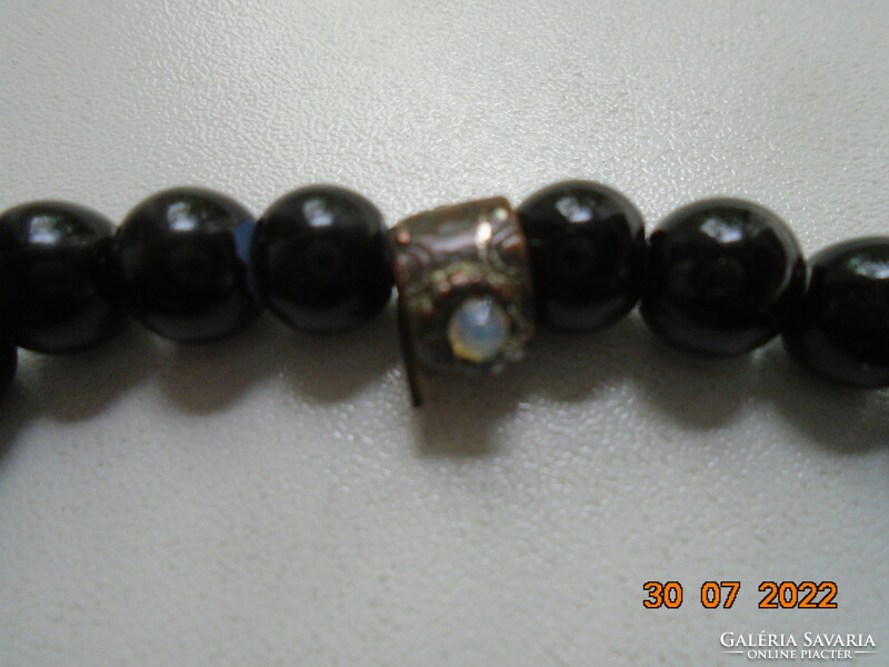 Black pearl bracelet with an interesting handcrafted bronze pearl decorated with 2 polished moonstones