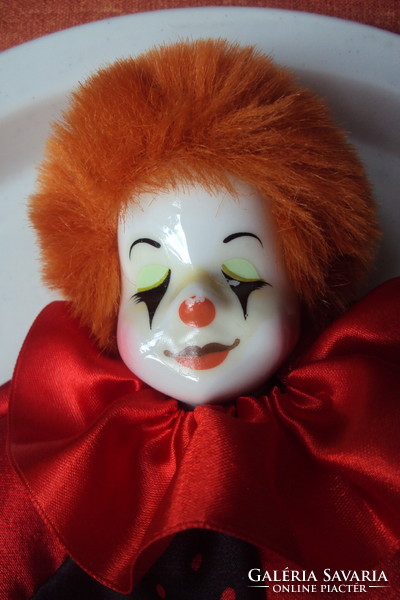Antique clown doll with porcelain head, red hair, in new clothes.