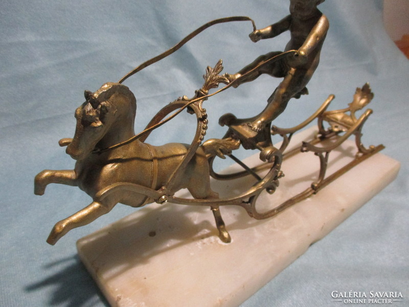 Antique metal sleigh on a stone slab