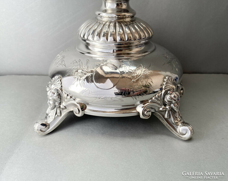 Decorative silver table base.