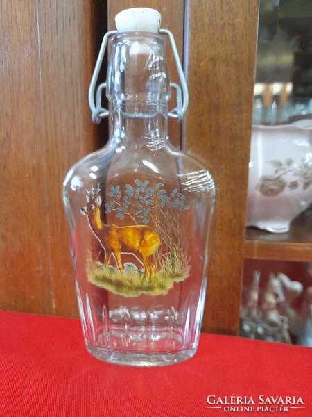 Flat glass bottle with Italy deer pattern buckle.