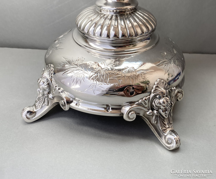 Decorative silver table base.