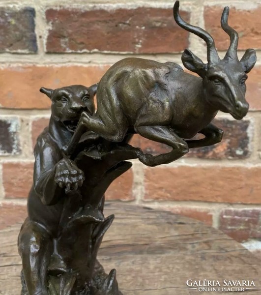Lion attacking antelopes - bronze sculpture artwork