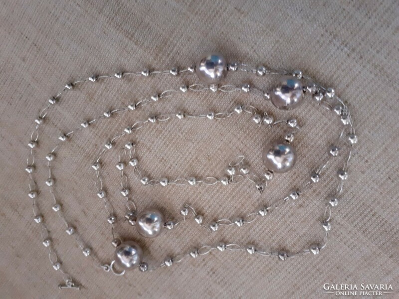 Silver-plated long necklace made of small and large balls with elaborately soldered eyes