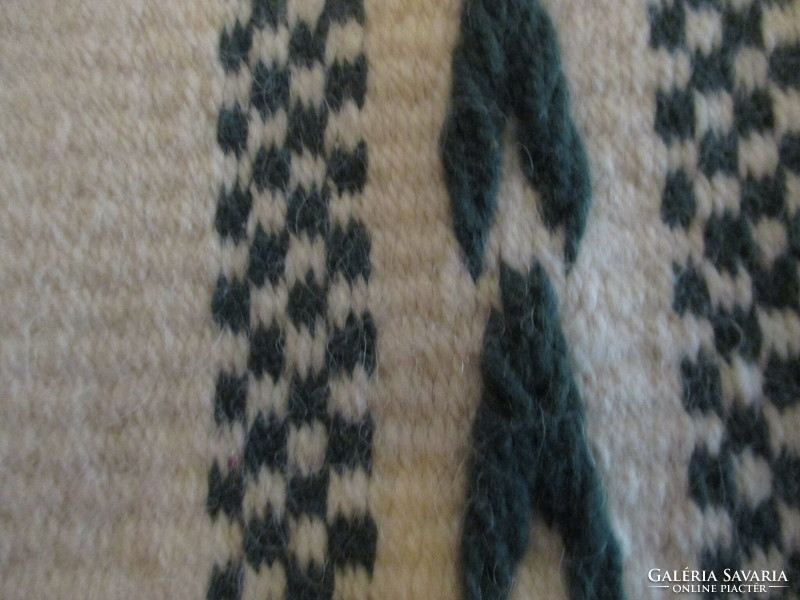 Small wool rug, green pattern on a raw base