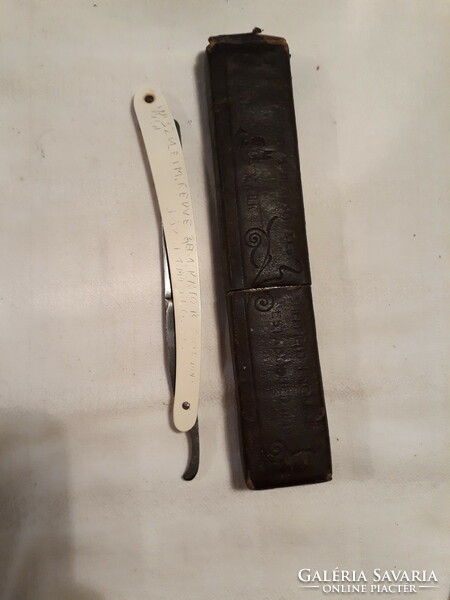Old razor with paper case