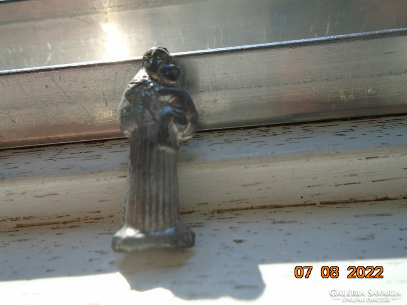 A souvenir from the Polish pilgrimage site of Jasna Góra in a sacred antal metal mini figurine in a book-shaped holder