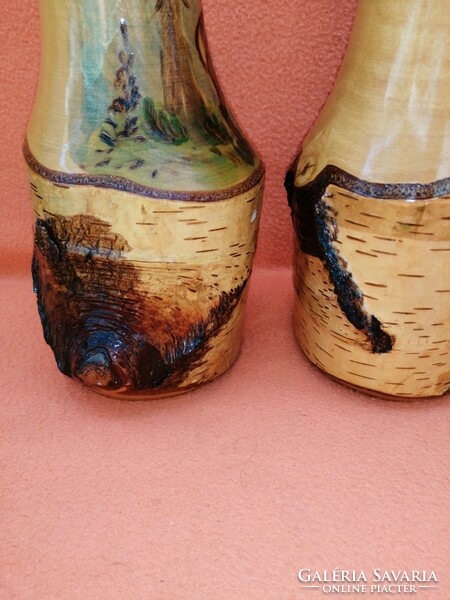 Pair of 2 carved wooden vases decorated with a deer pattern.