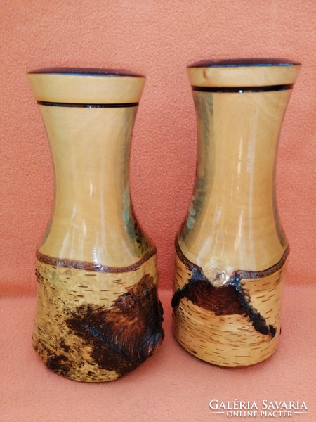 Pair of 2 carved wooden vases decorated with a deer pattern.