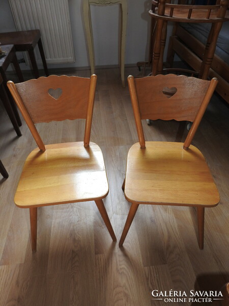 Old wooden children's small chair with heart decor on the headrest