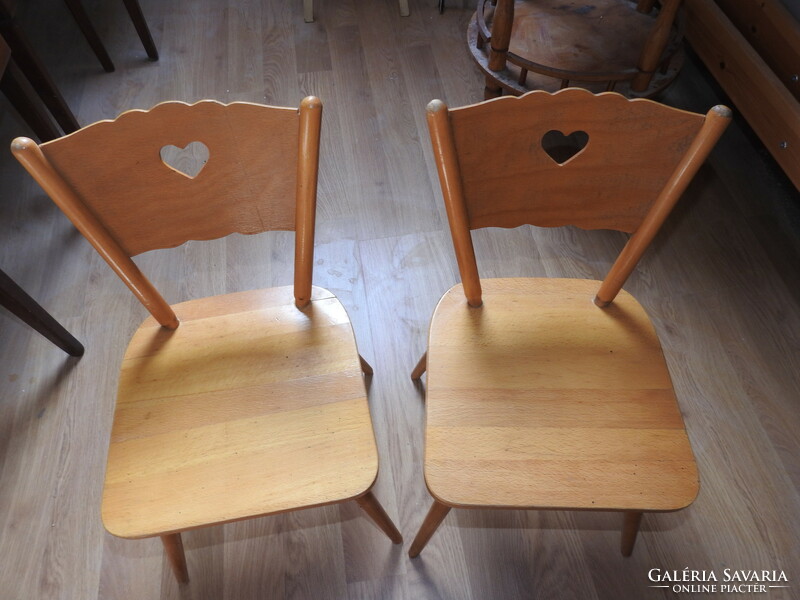 Old wooden children's small chair with heart decor on the headrest