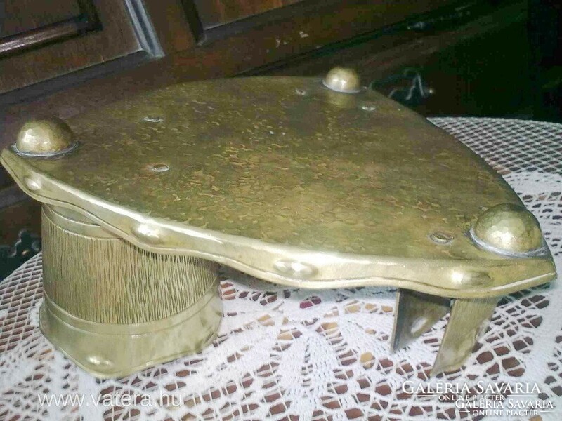 An antique copper desk centerpiece is also handmade