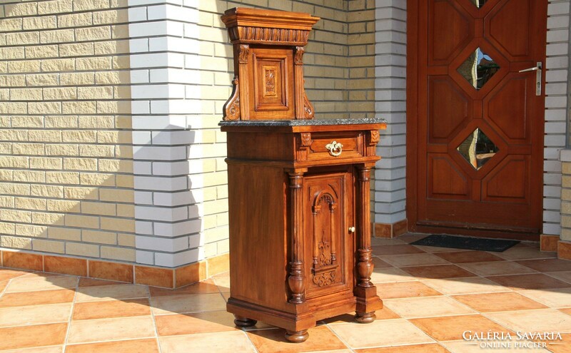 Bedside table with a marble top with a tin-carved superstructure
