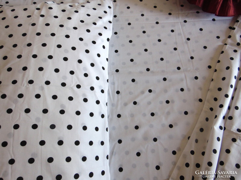 Black polka dot bedding set on a white background