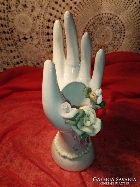 Hand holding a porcelain ring.