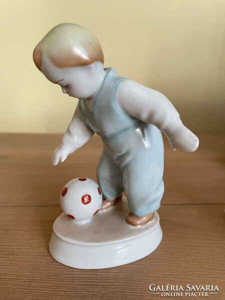 Child kicking a ball - Zsolnay porcelain