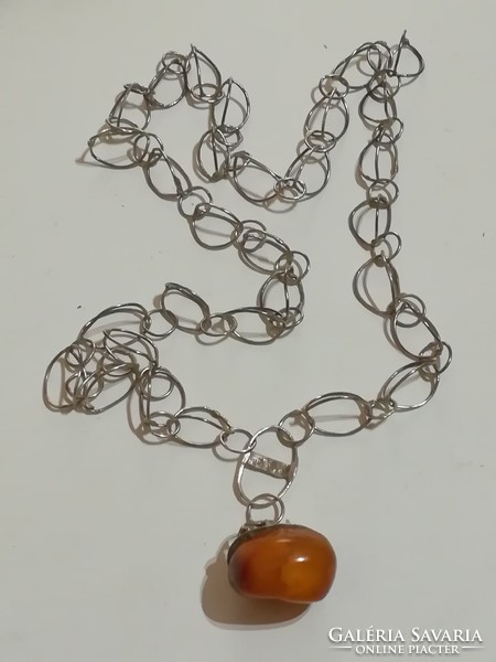 Antique silver chain with amber pendant.