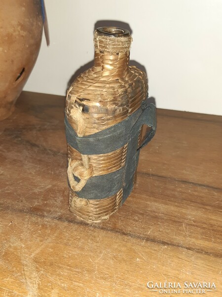 Regi glass bottle, in a wicker case