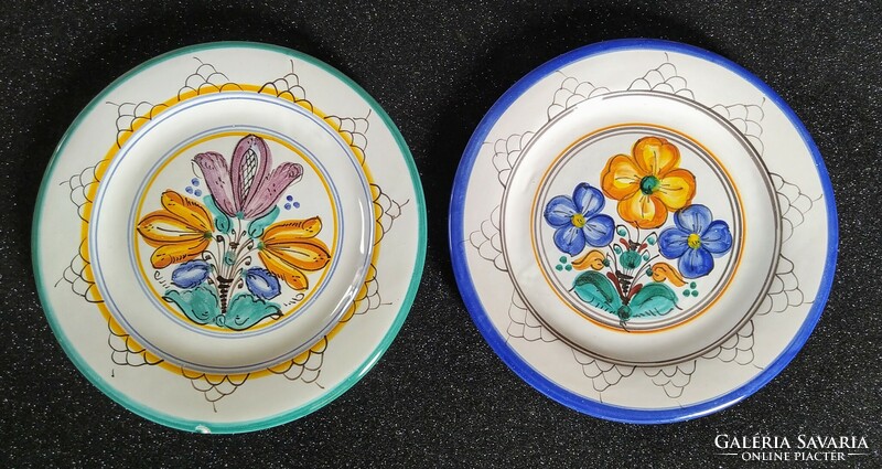 A pair of decorative ceramic plates with a Habán motif