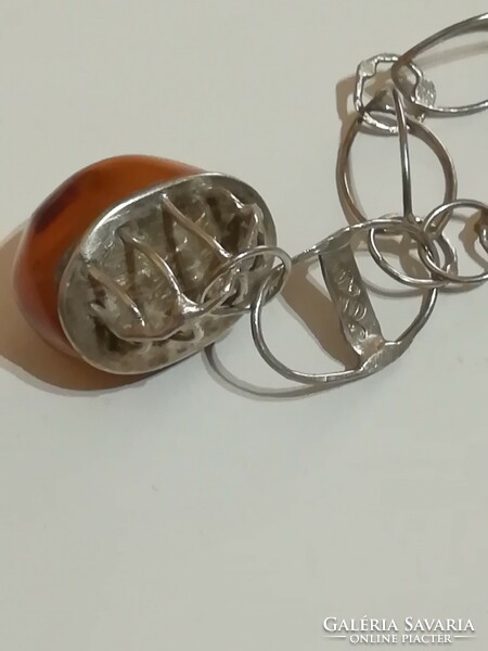 Antique silver chain with amber pendant.