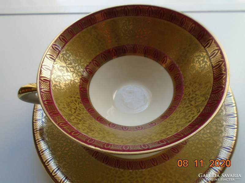 Rich gold brocade with burgundy patterned tea cup with saucer