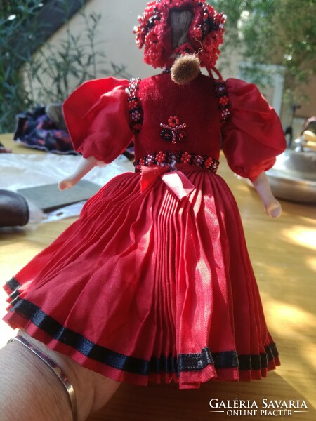 Folk costume doll, with a porcelain head, in a beaded dress