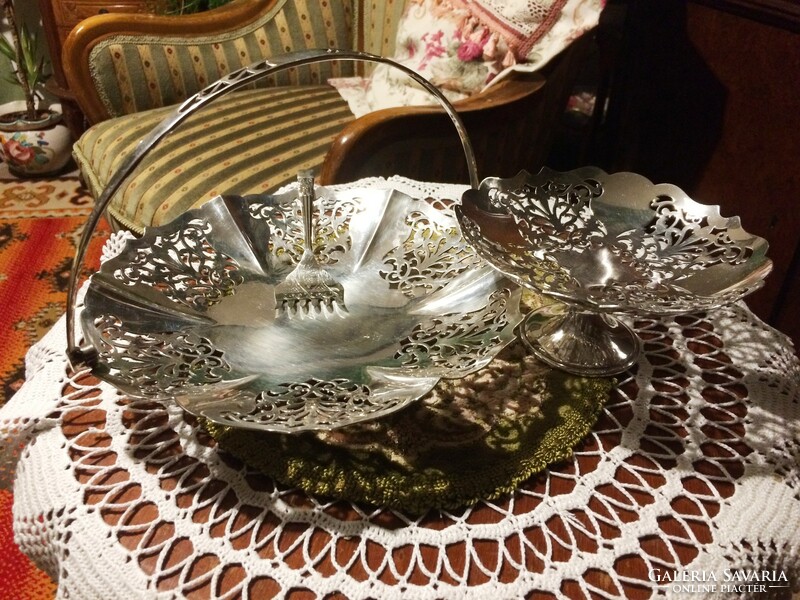 High-gloss, shiny, silver-plated, openwork, serving bowl with handles and a small bowl with a base, with a serving fork