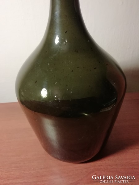 Large dark green wine bottle with demizon