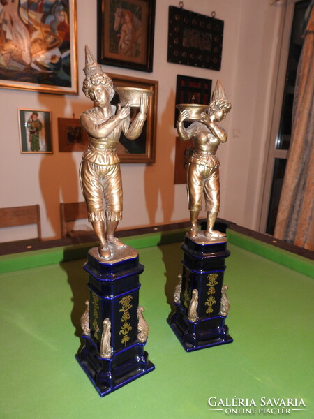 A pair of figural candlesticks, cast patinated bronze, on a porcelain base, 51cm