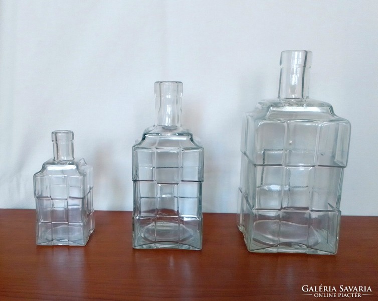 Three old, rare, square zwack liquor bottles with the characteristic cross mark, unicum