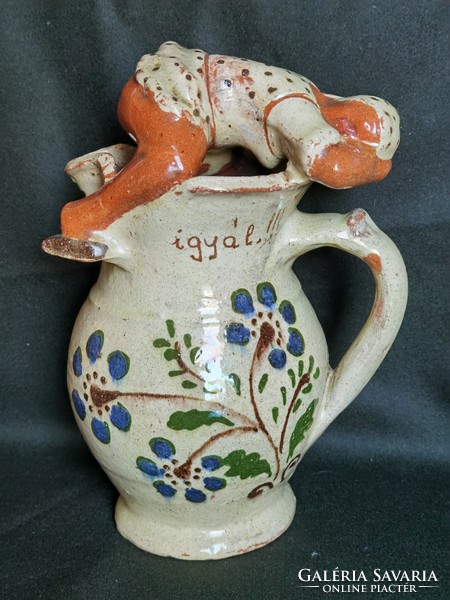 Jug with wine jug on old shield