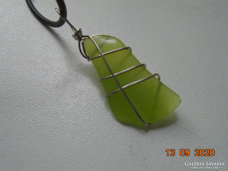 Uranium green mineral pendant with a new label in a metal socket, with a rubber necklace