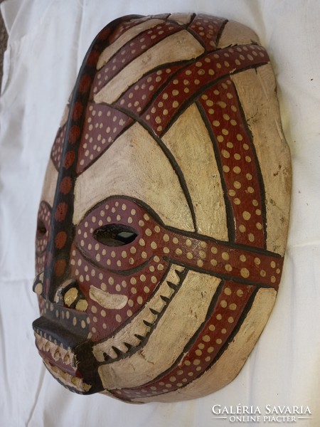 Carved wooden mask can be negotiated from a special collection