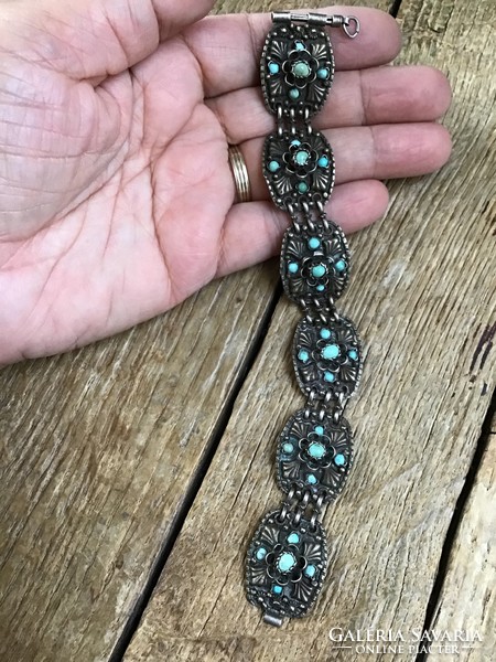 Antique handcrafted silver bracelet decorated with turquoise stones