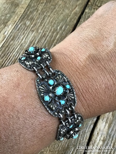 Antique handcrafted silver bracelet decorated with turquoise stones