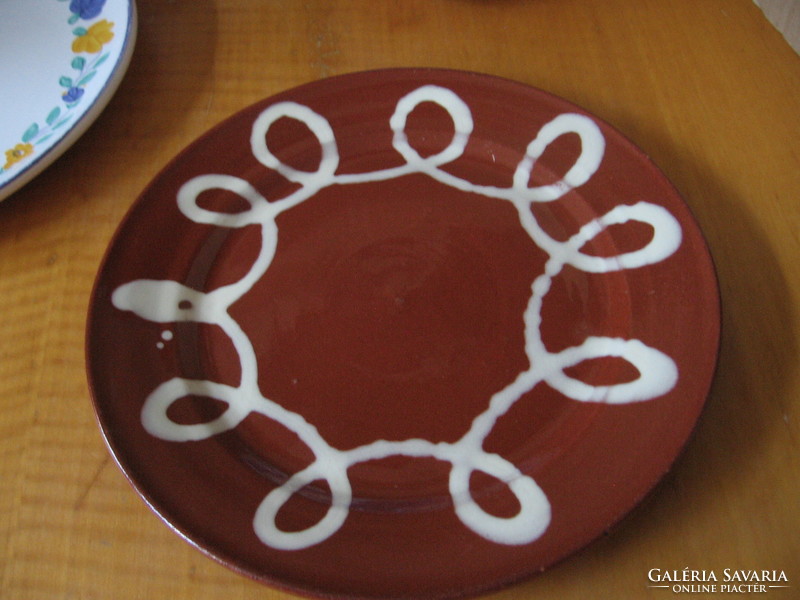 Thick, brown Greek majolica plate with a meander pattern.