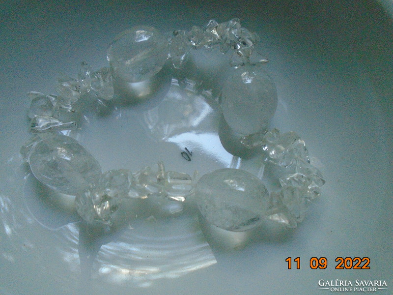 Bracelet made of 4 larger polished rock crystal beads and smaller irregular nuggets