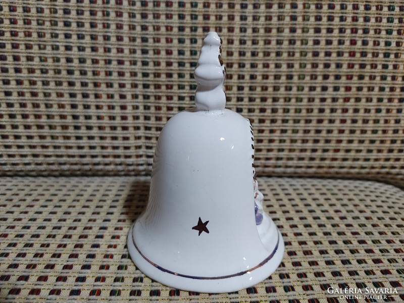 Porcelain table bell with a religious scene inlay.