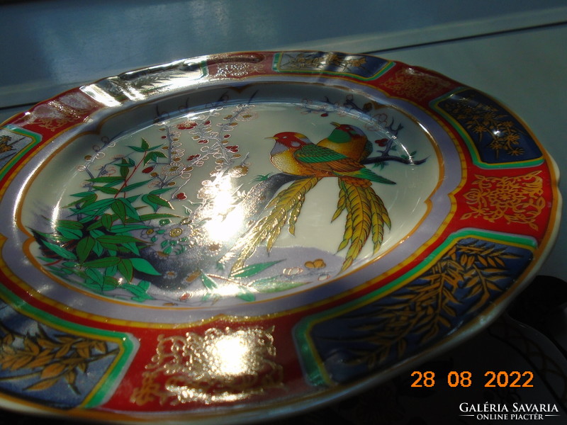 Hand-painted oriental marked wall plate with a bird flower pattern with bright protruding colors