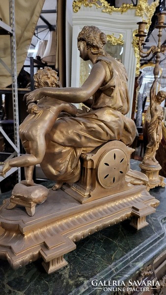 Fire-gilt bronze Empire mantel clock with candle holders